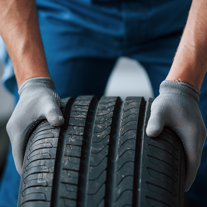 Mechanic holding a tire at the repair garage