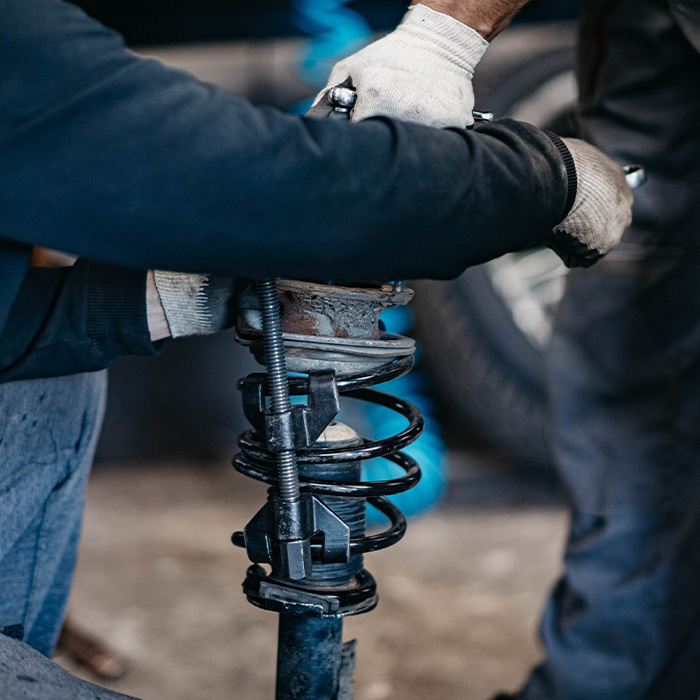 Spring replacement car suspension repair in the garage